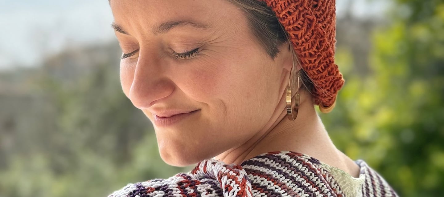 Sophie wearing her shawl in hand-dyed eco-friendly yarn