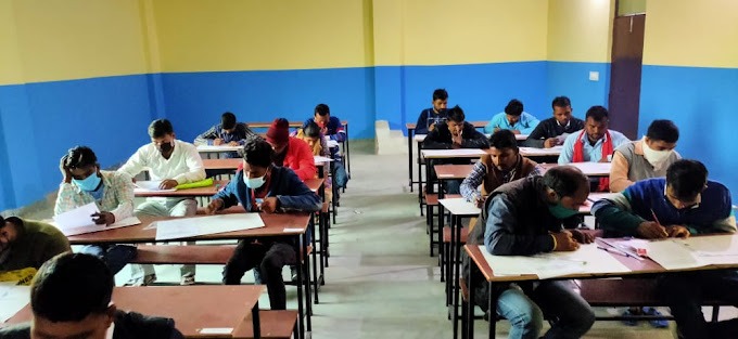 a classroom with many students sitting at desks