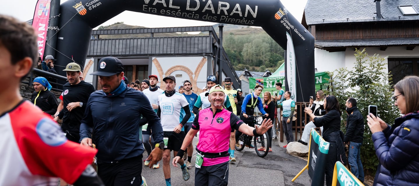a man running in a race with a woman in pink