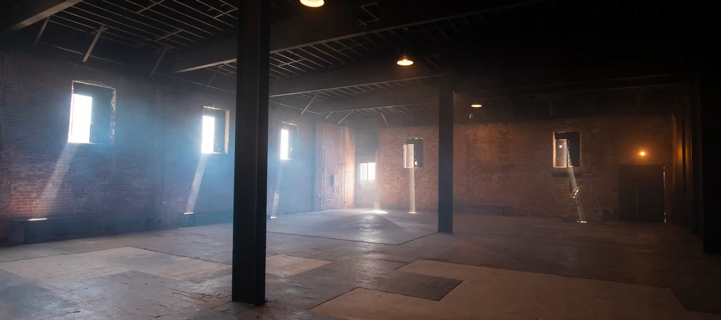Spacious industrial warehouse loft at Grayfox Studios with exposed brick walls, beams, and natural