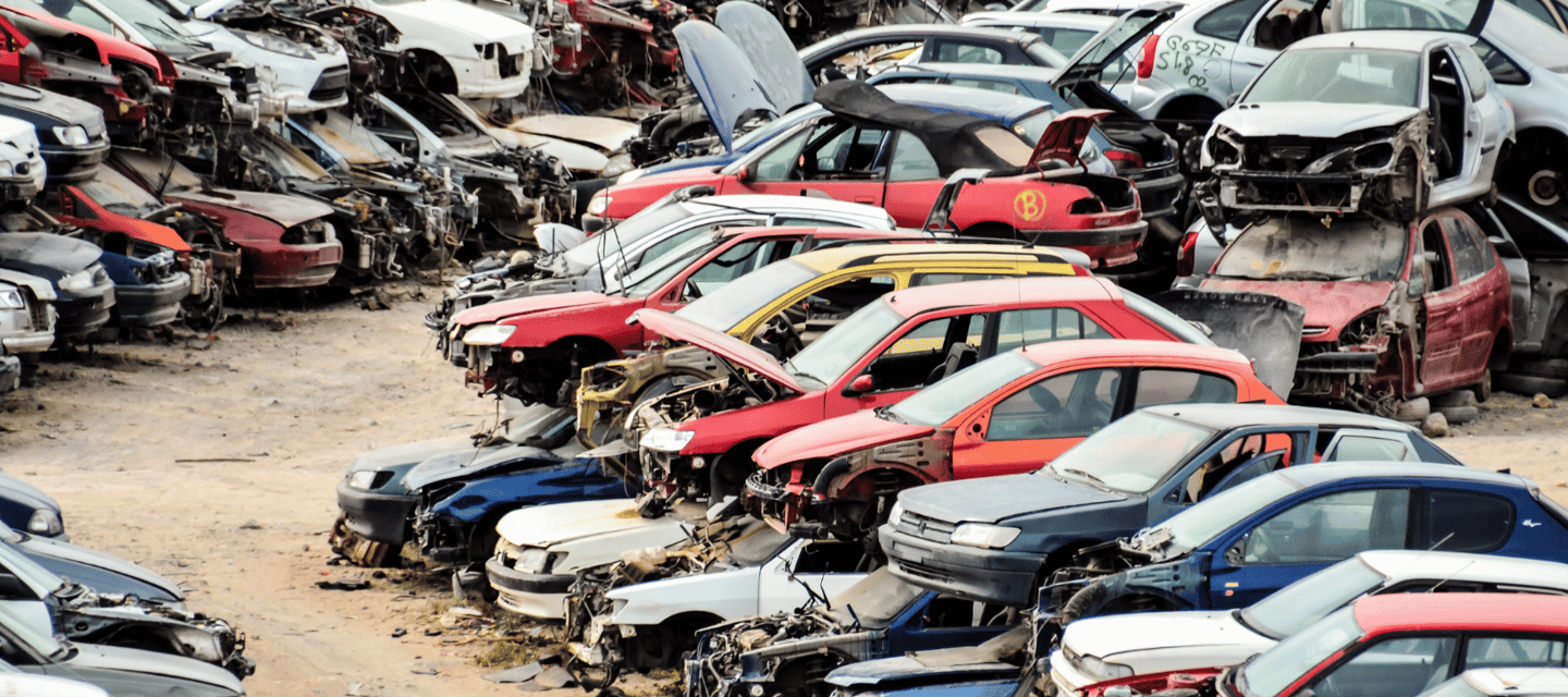 A bunch of old cars parked in a Surrey junkyard