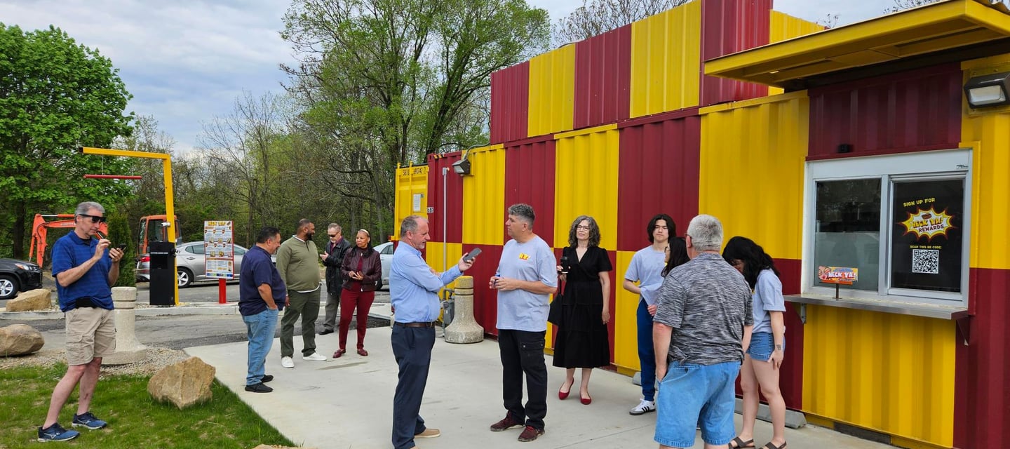 Bright red and yellow HeckYA shipping container drive-through restaurant on McCartney Rd Youngstown