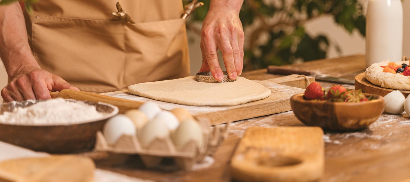 cook preparing dough to make pastries