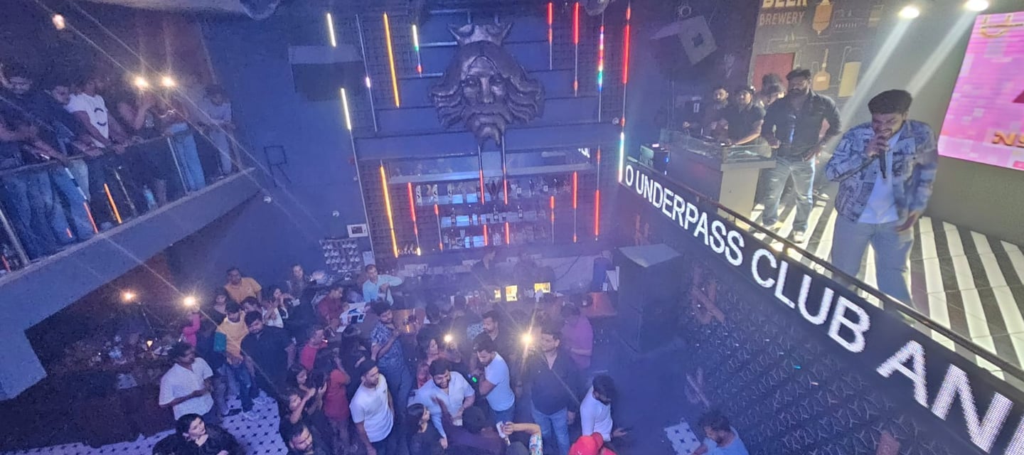 a group of people standing around a bar