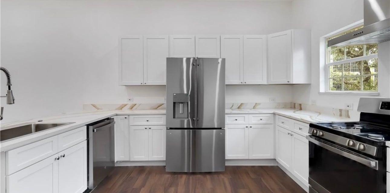 Custom kitchen featuring stainless steel fridge and modern cabinetry