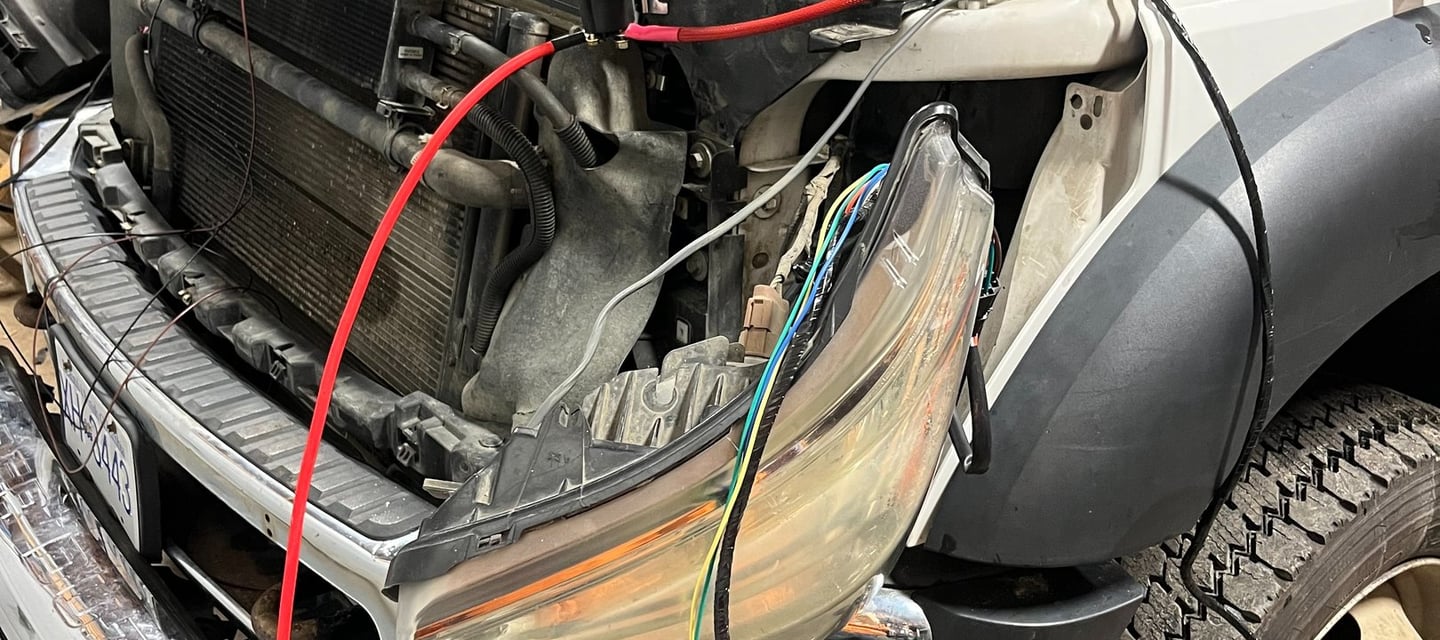 truck with its hood open and wires hanging out of it
