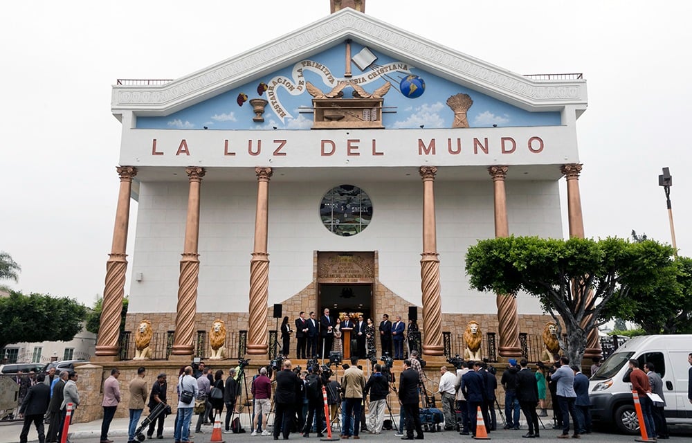 The exterior of La Luz Del Mundo church in Los Angeles during a crowded press conference.