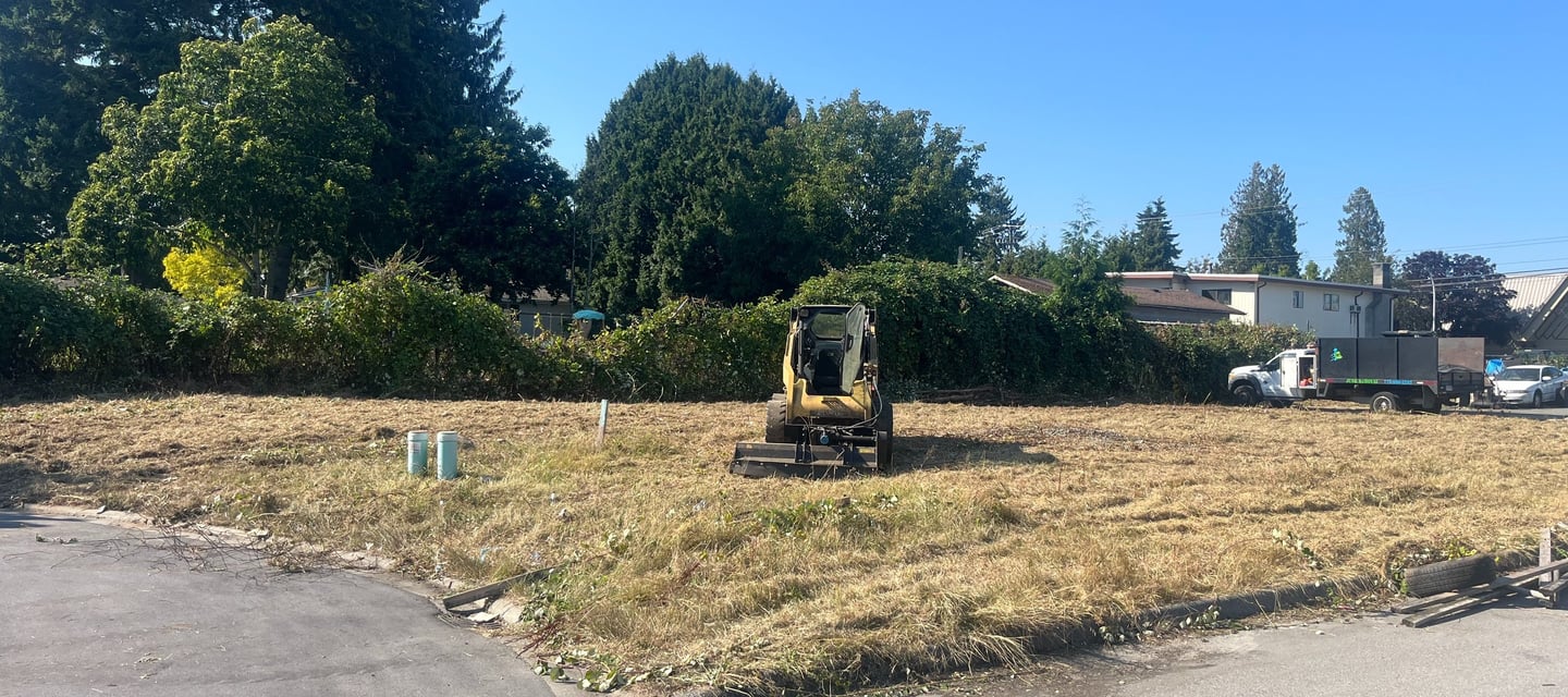 A machine in the middle of a field it cleared.