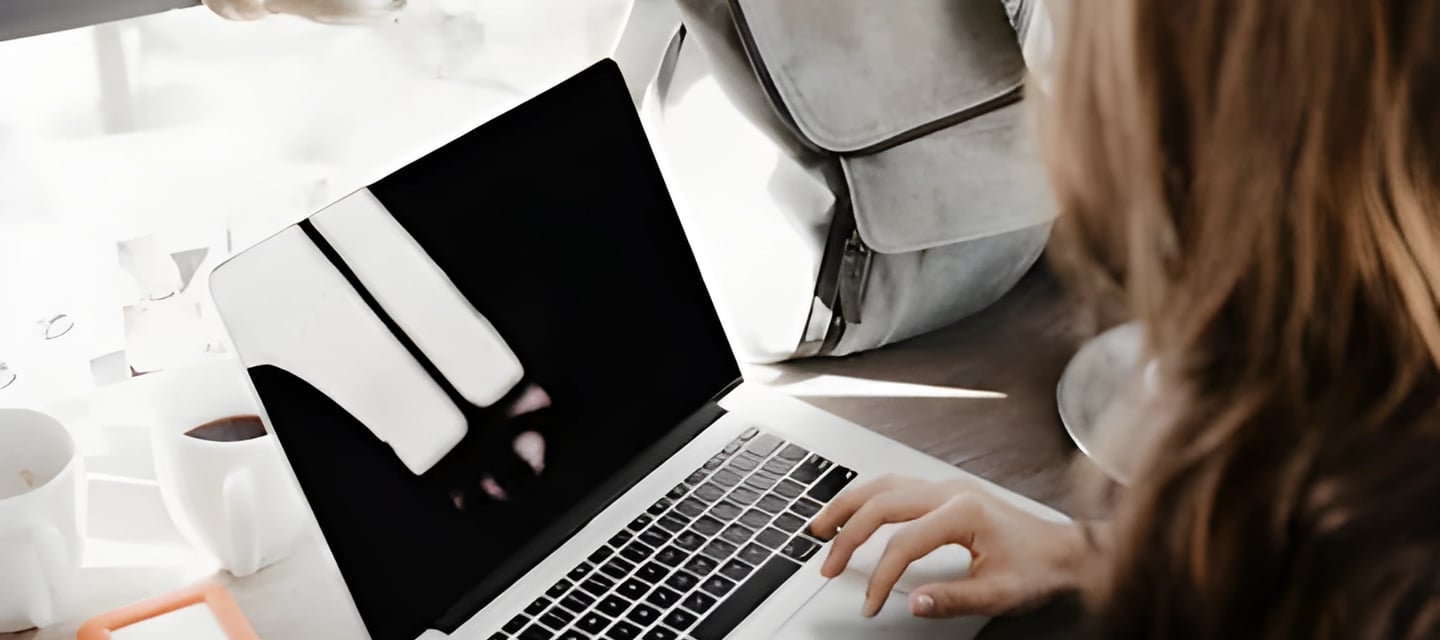 Hands typing on a laptop, symbolizing end-to-end assistance by Admit 360 for studying abroad