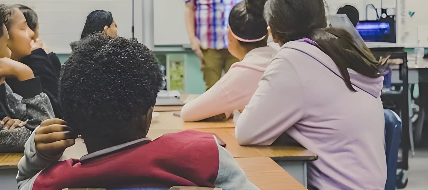 Teacher addressing students in classroom, demonstrating Admit 360's online test preparation