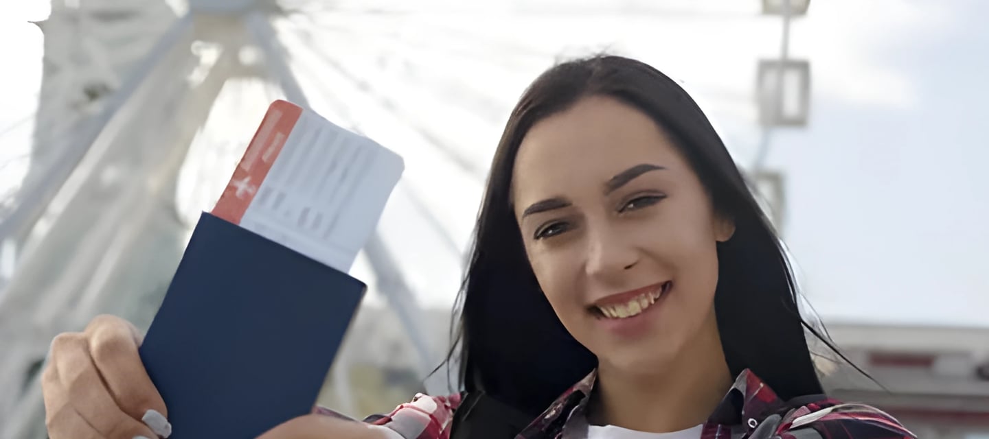Woman smiling with passport and ferris wheel backdrop, illustrating Admit 360's support