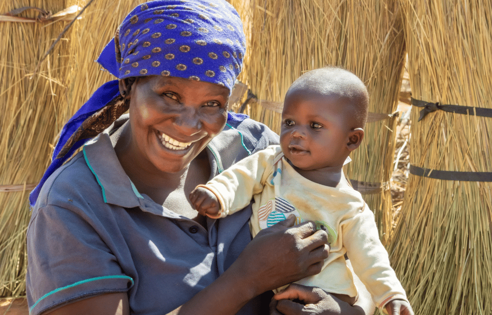 a woman in a blue shirt and a baby in a blue shirt
