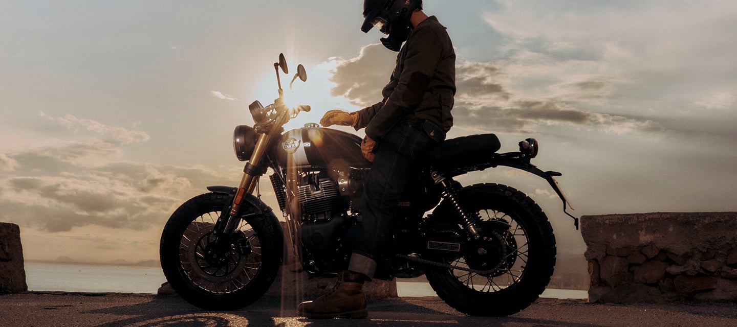 a man in a helmet and a helmet on a motorcycle