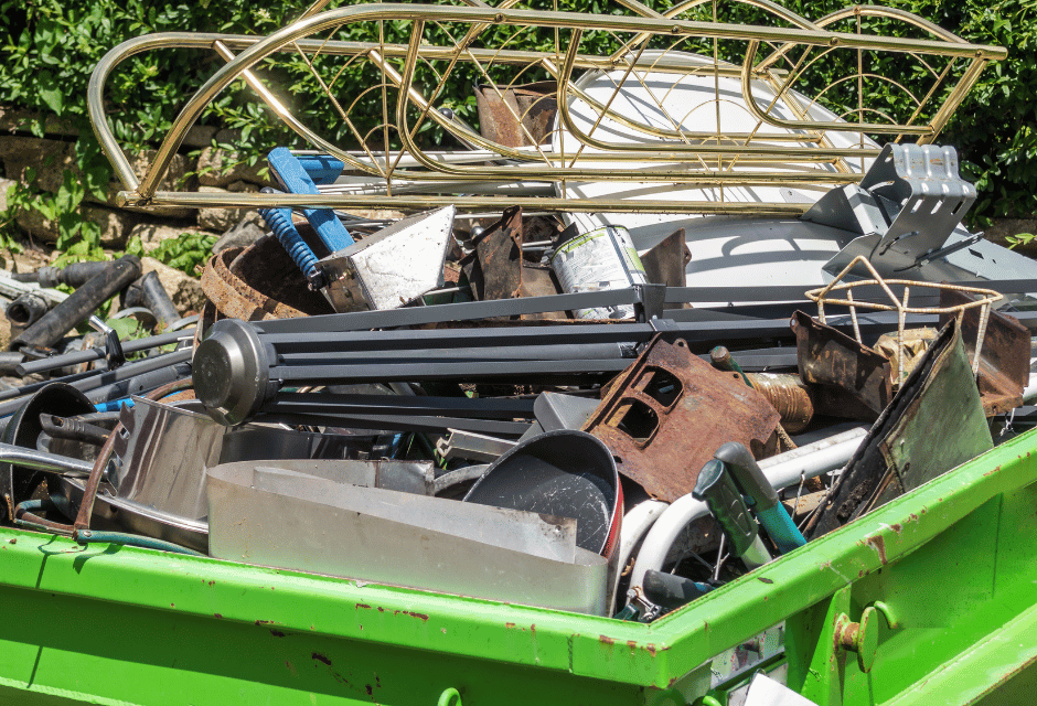 a green steel bin filled with metal scrap 