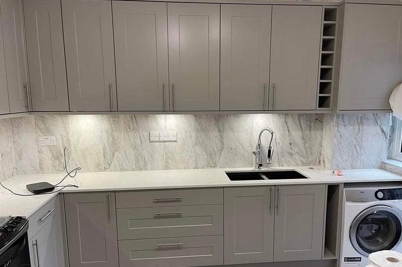 Modern grey shaker kitchen cabinets with integrated washing machine by Roman Refurbs