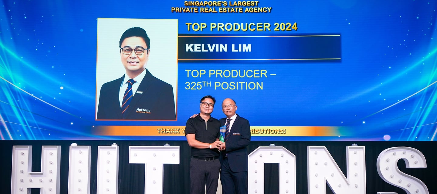 Huttons Real Estate Top Producer Kelvin Lim receiving an award on stage in Singapore.