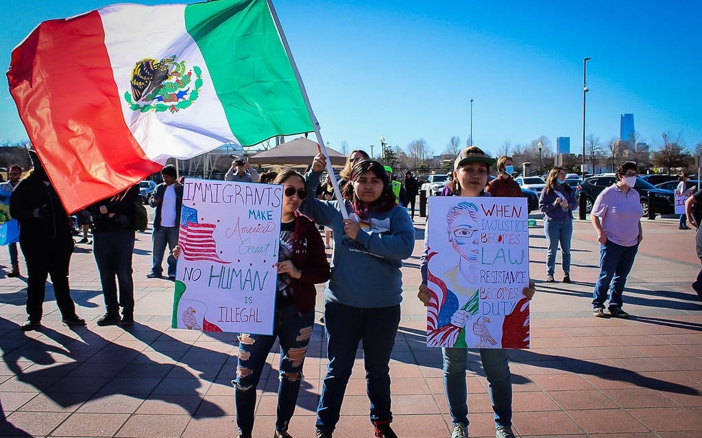 a group of people holding up signs at an event with Organizing Okies