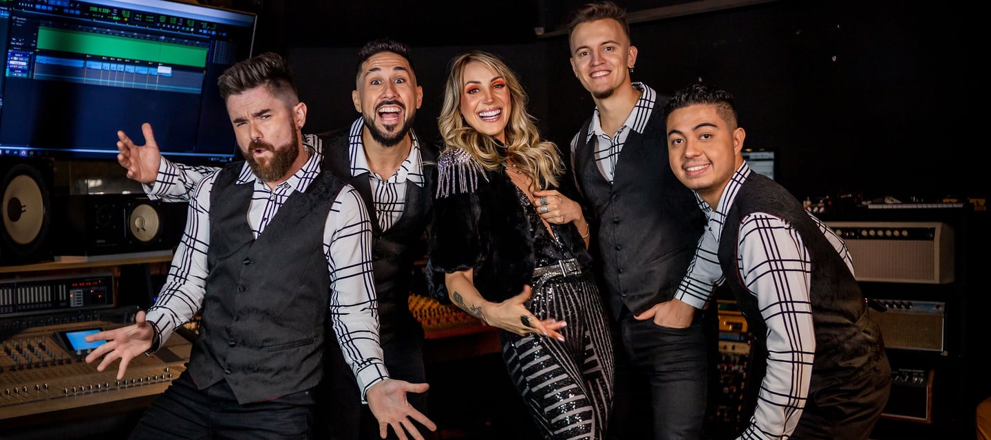 The five members of Mashup Band standing side by side, striking fun poses.