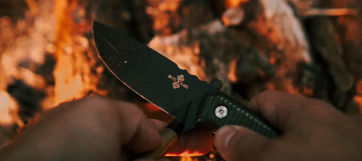 a person holding a knife and a knife in their hand varnas baltic blades