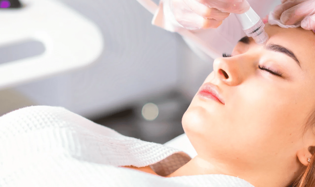 Professional esthetician performing a microneedling skin treatment at Skin Therapy Solutions