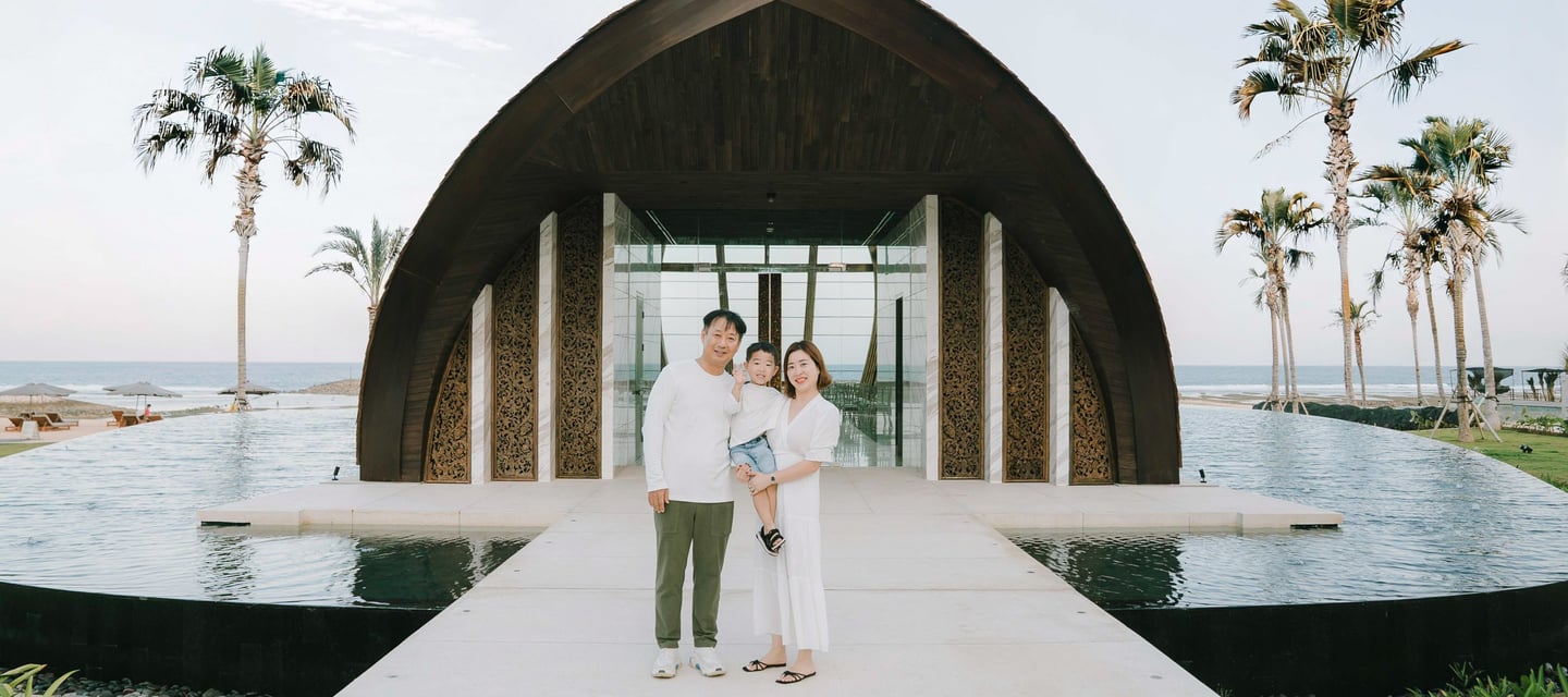 Family portrait in front of the iconic chapel architecture at The Apurva Kempinski Bali.