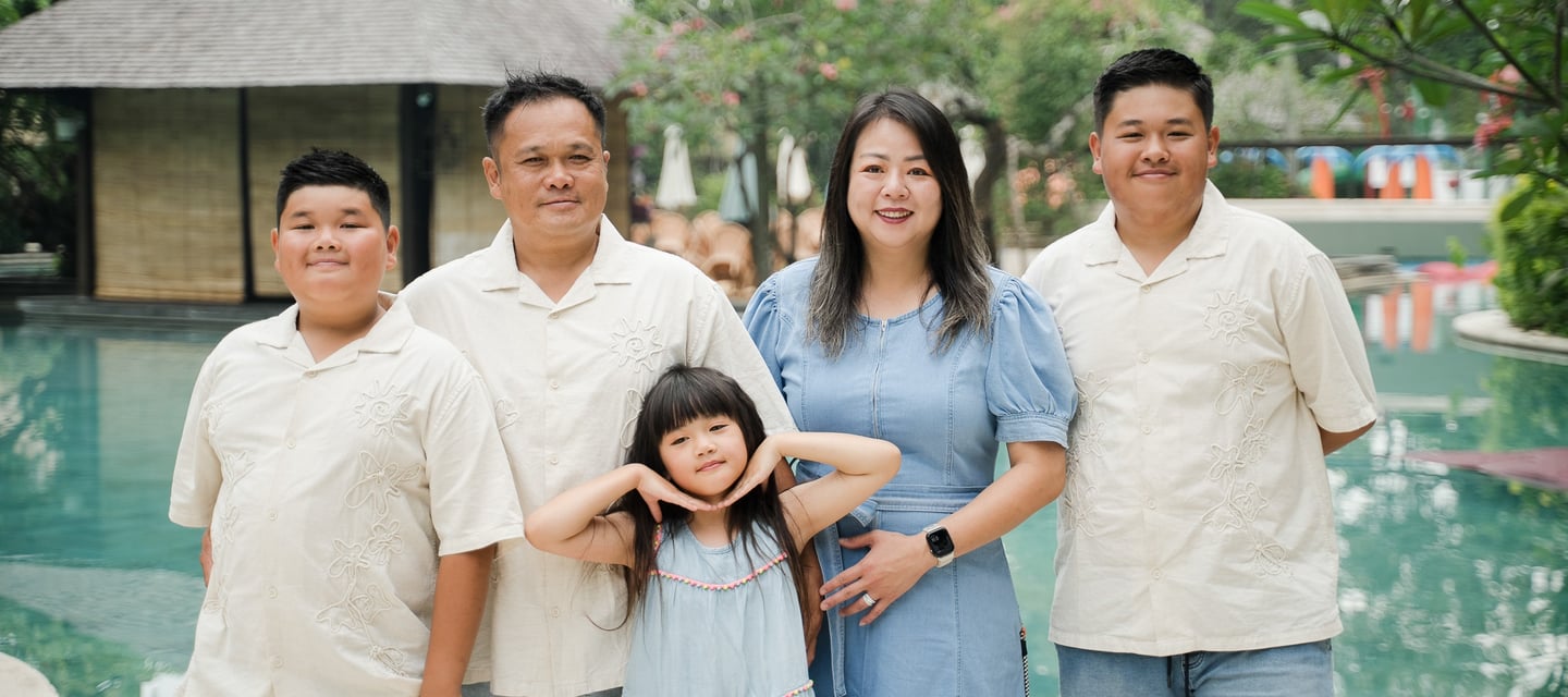 extended family posing together near the pool at Movenpick Jimbaran Bali during a relaxed session
