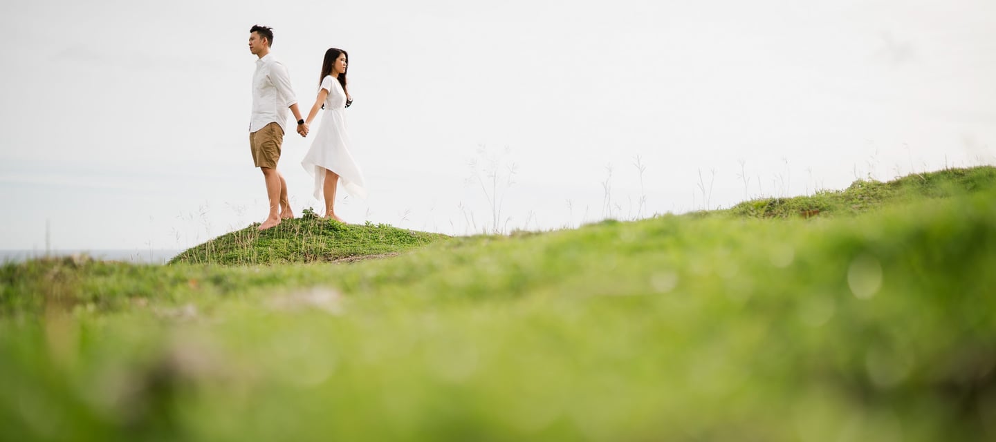 Couple proposal moment on a cliff at Melasti Beach Bali with ocean view