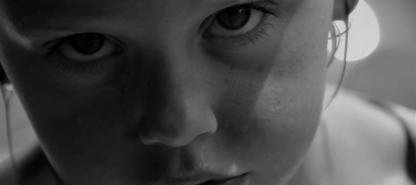 Close up of a young girl looking directly into the camera