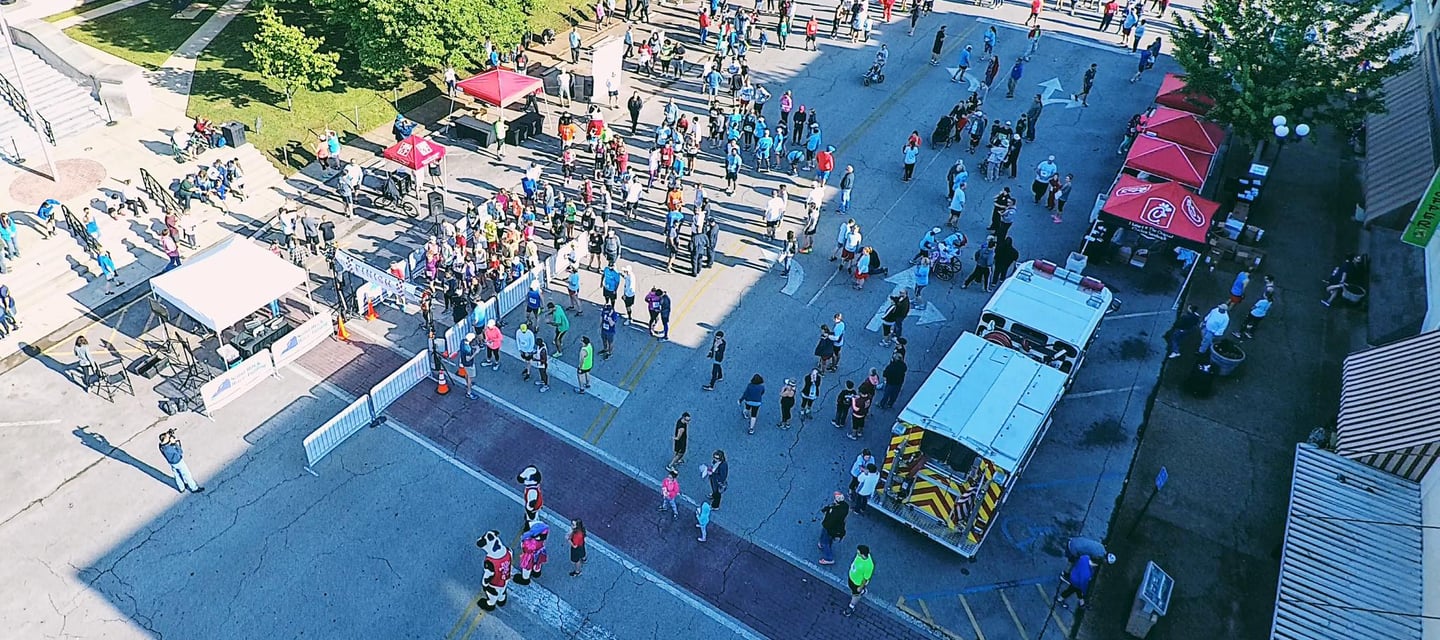 an overhead drone photo of the starting line and vendor expo at the chick fil a 10K in athens, AL