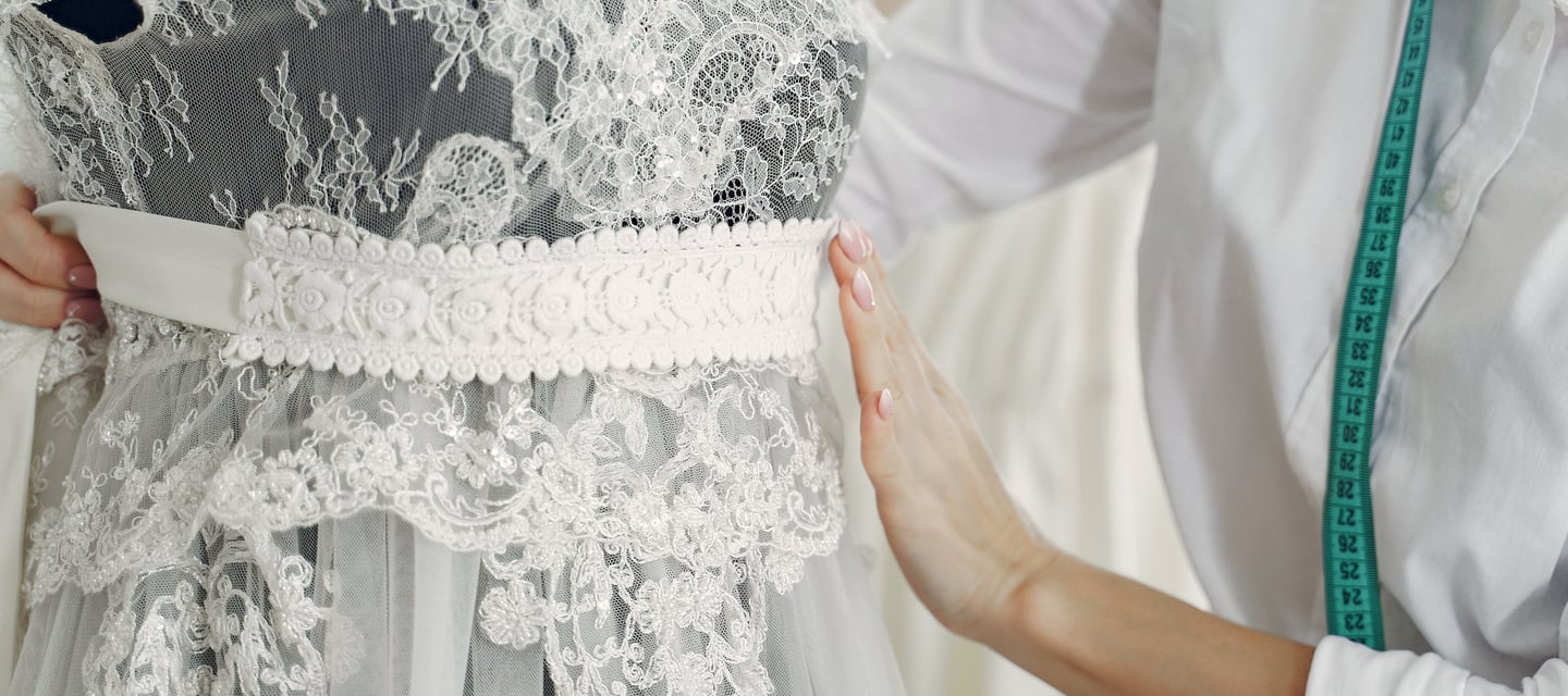 a woman working with a wedding dress