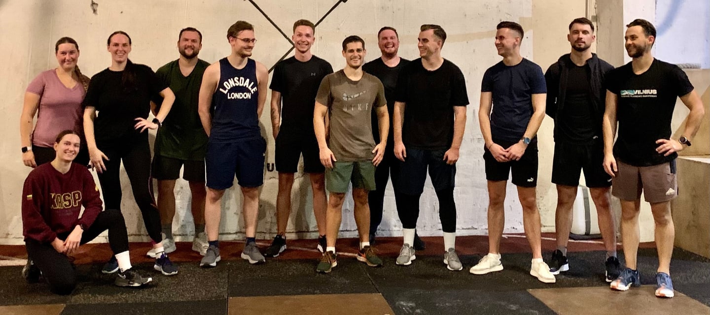 a group of people standing in front of a wall