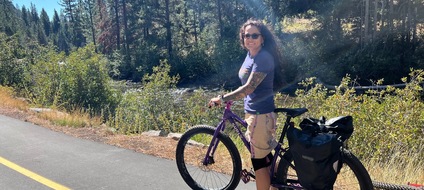 a woman riding a bike on a road