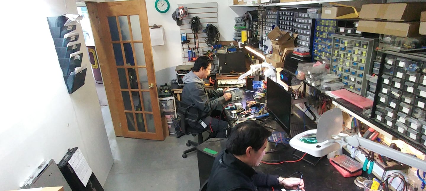 a man working on a computer in a room