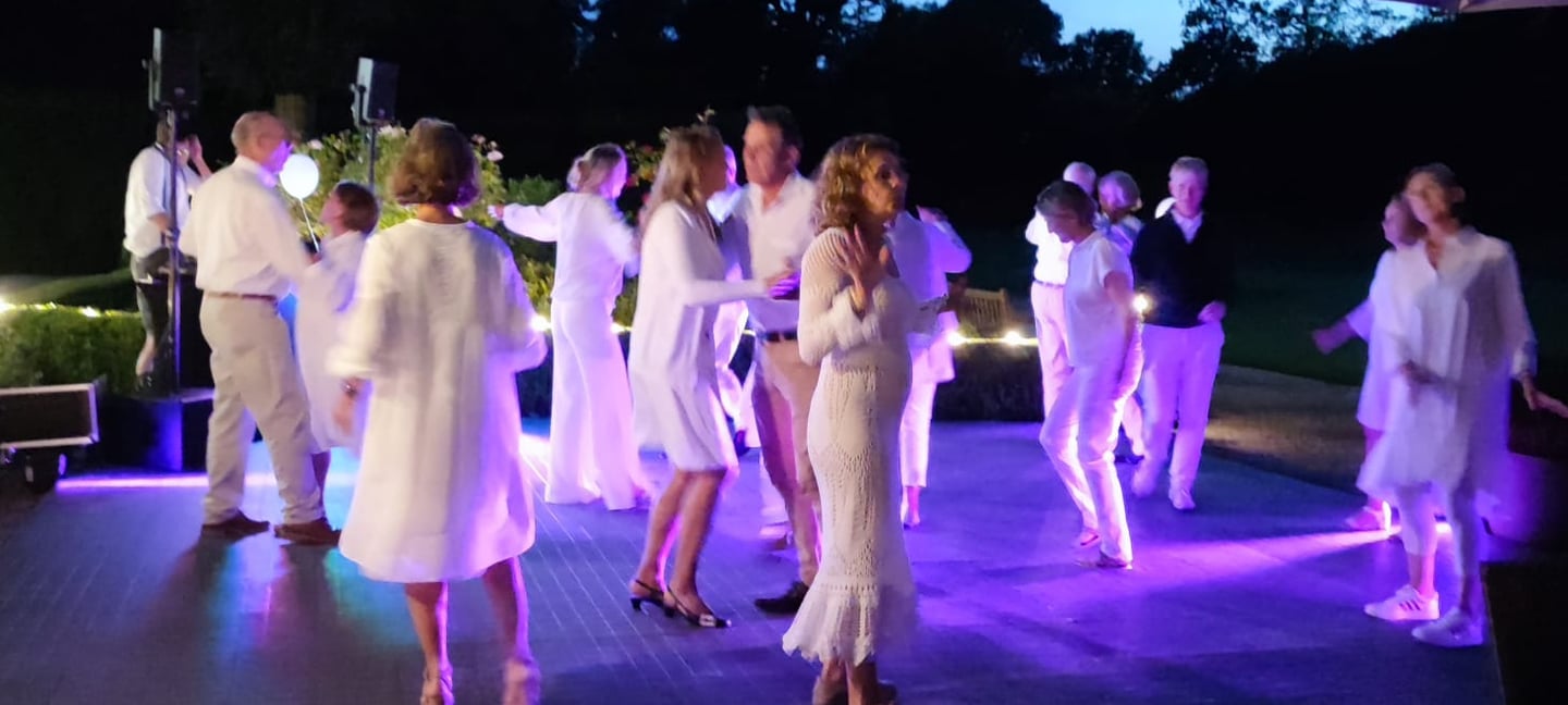 a group of people standing around a table with drinks