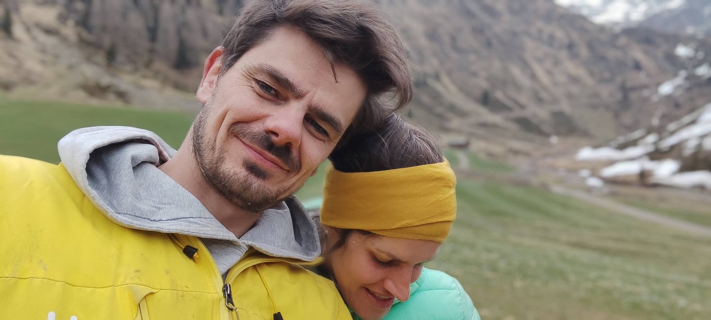 a man and woman are smiling and hugging
