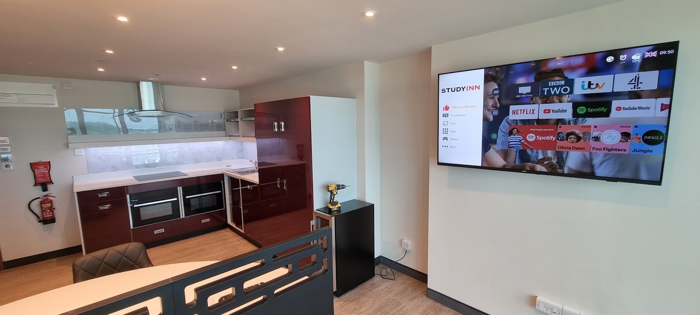MountMyTV - Samsung 65" TV mounted on a wall in a university communal area