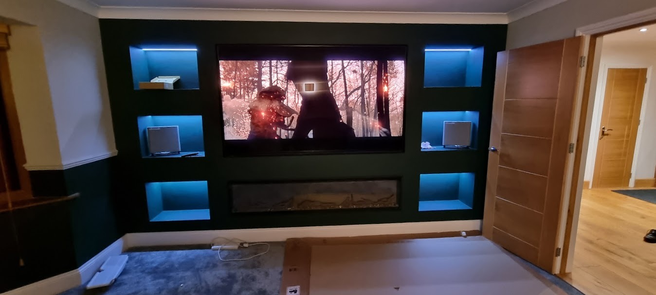 Luxury bespoke media wall featuring ambient LED lighting and professional TV mounting.