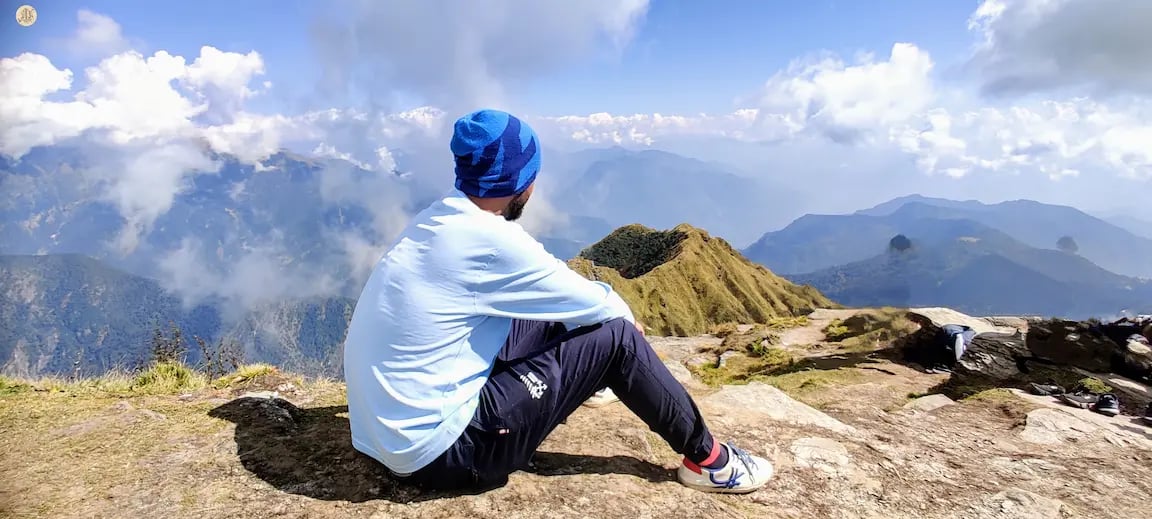 View from Chandrashila Summit, Uttarakhand Himalayas, panoramic snow-capped peaks and sky.