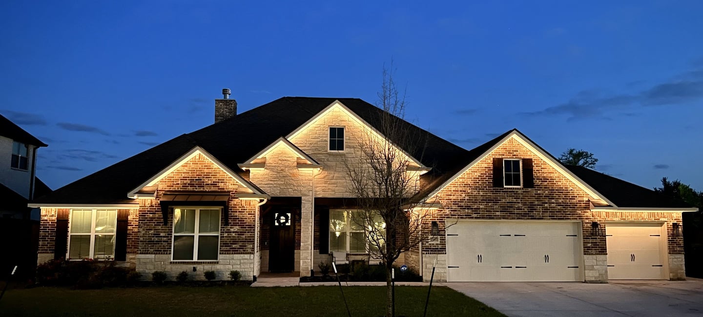 White inward facing permanent lighting on home
