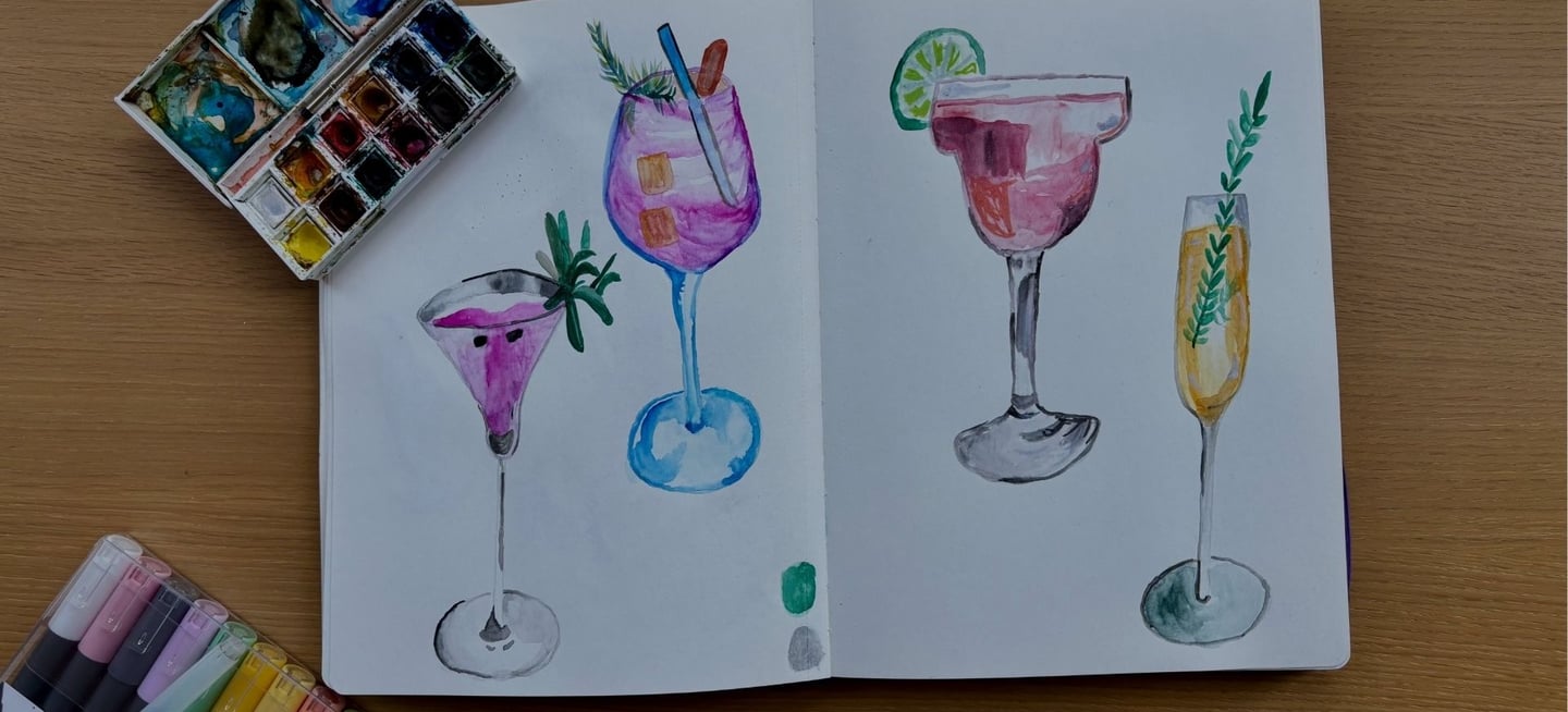 a book opened to show a drawing of a cocktail