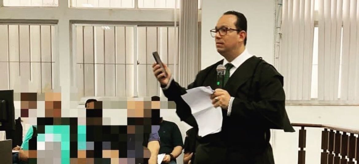 a man in a suit and tie is holding a cell phone