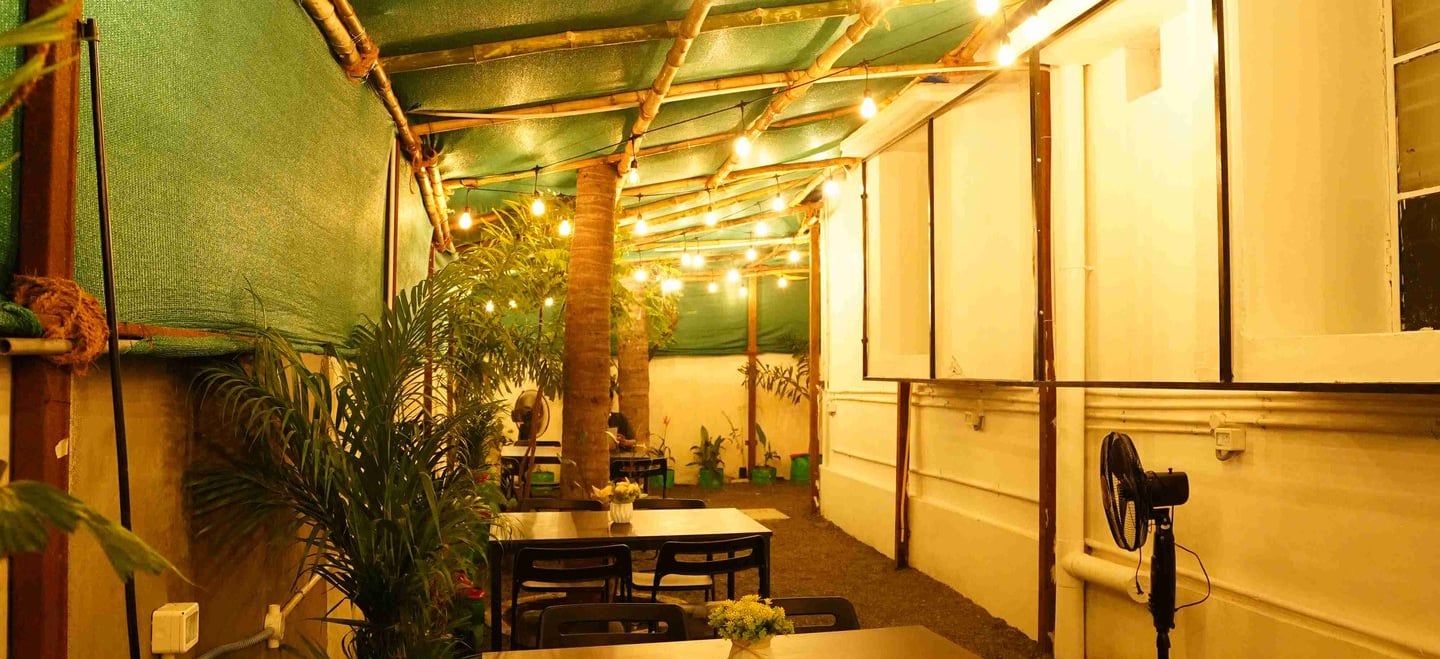 a restaurant with a table and chairs in the garden area