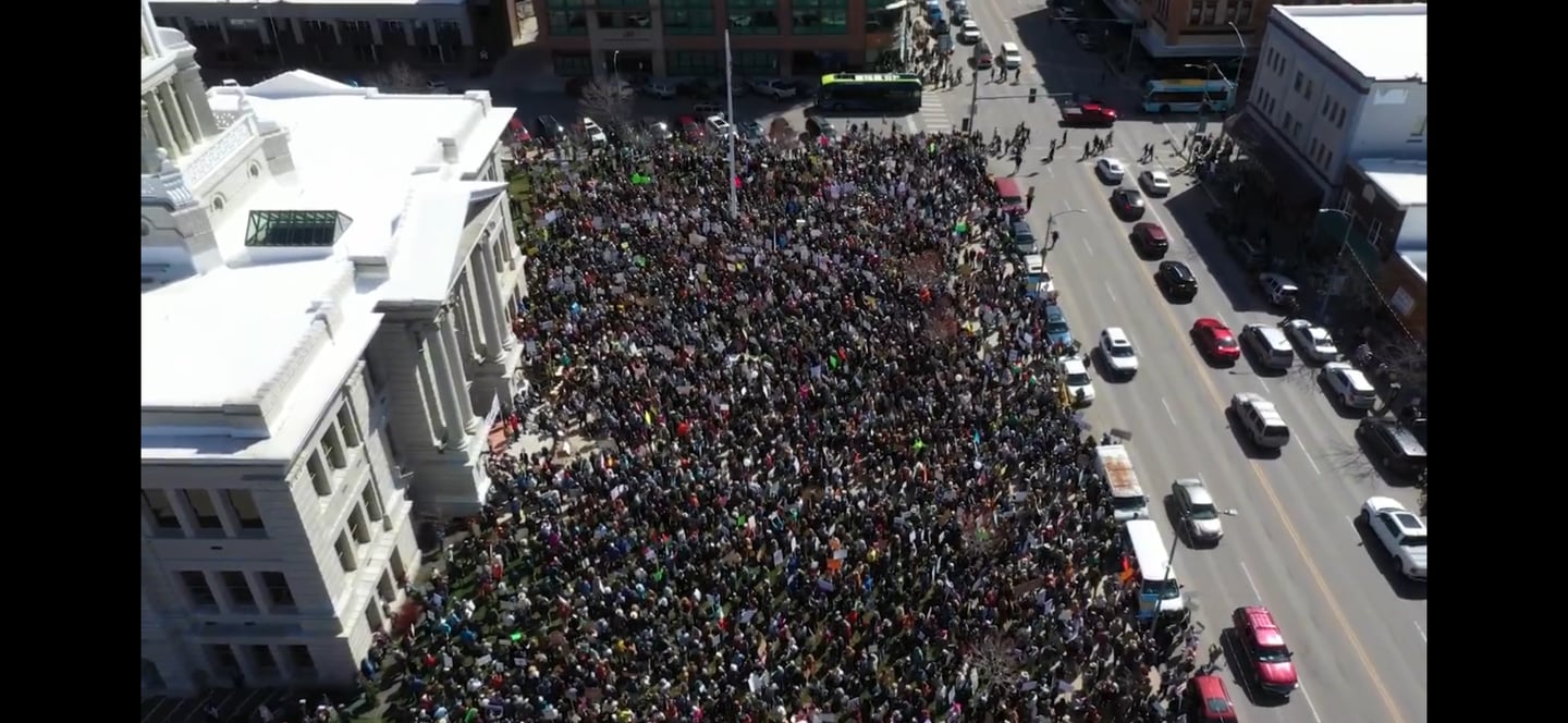 Aerial view of a large crowd of protesters gathered for a demonstration outside the courthouse