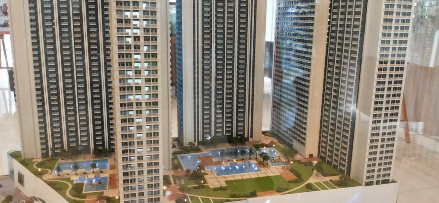 a model of a building with a large building in the background