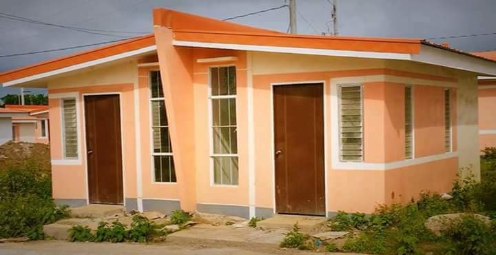 a small house with a red roof and a red door