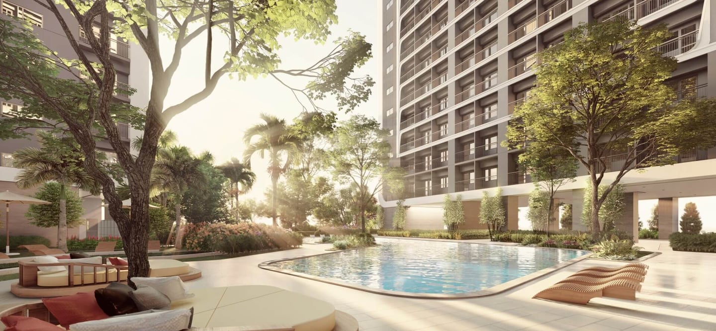 a large swimming pool with lounge chairs and a lounge area