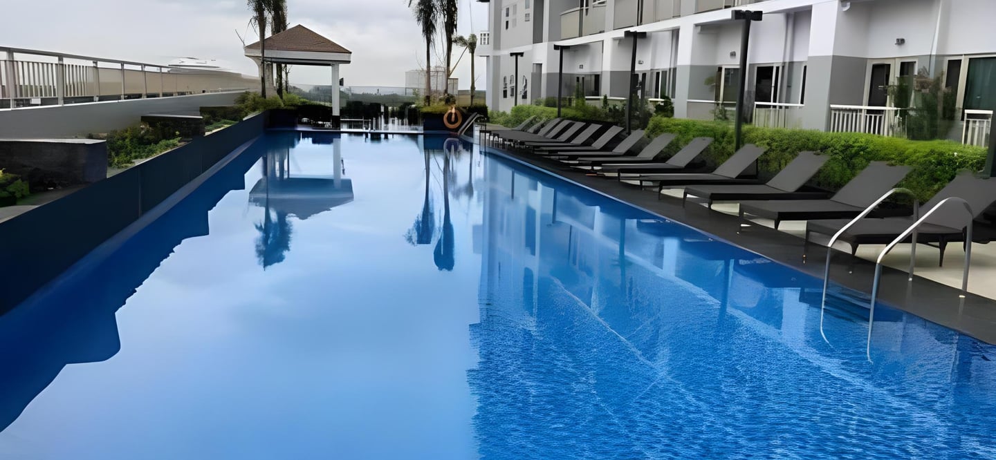 a pool with lounge chairs and lounge chairs