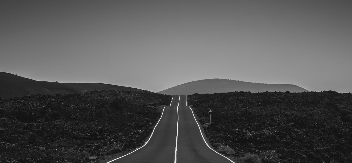 a long road with a road sign on it