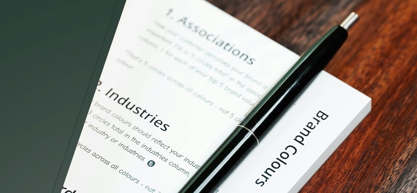 green notebook, document and pen