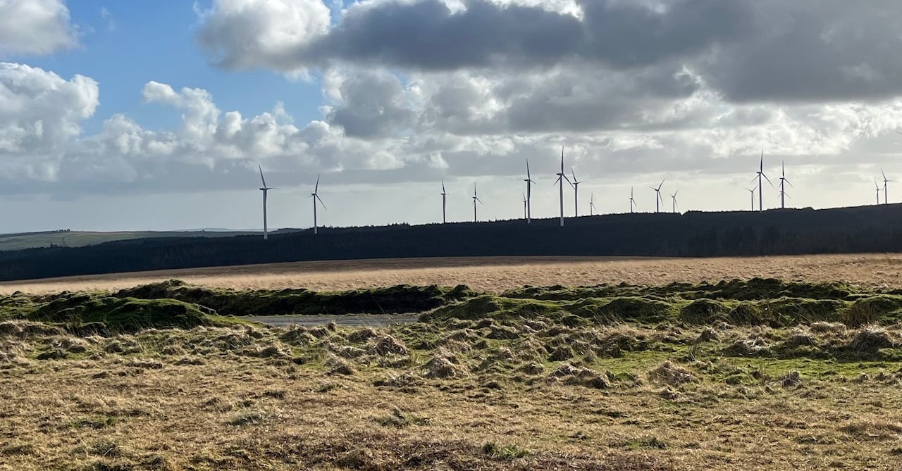 View of the moorland with wind turbines on the horizon